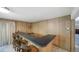 Retro basement bar with wood paneling, an elevated counter and traditional barstools at 13955 W 26Th Ave, Golden, CO 80401