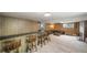 Basement with a bar area featuring wood paneling, plenty of counter space, and room to entertain at 13955 W 26Th Ave, Golden, CO 80401
