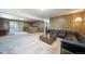Spacious basement featuring a retro bar, wood paneled walls, and a comfortable seating area at 13955 W 26Th Ave, Golden, CO 80401
