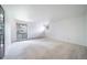 Sunlit bedroom with large window, soft carpeting, and neutral walls creating a serene space at 13955 W 26Th Ave, Golden, CO 80401