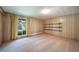 Inviting bedroom featuring wood-paneled walls, soft carpet, and a bright window with curtains at 13955 W 26Th Ave, Golden, CO 80401