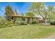 Inviting home featuring a well-manicured lawn and established trees for added privacy at 13955 W 26Th Ave, Golden, CO 80401