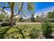 Traditional home with lush green lawn and mature trees for added shade and curb appeal at 13955 W 26Th Ave, Golden, CO 80401