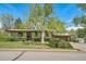 Charming home with green exterior, mature trees, and well-maintained lawn at 13955 W 26Th Ave, Golden, CO 80401
