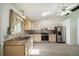 Bright kitchen featuring stainless steel appliances, a skylight, and a window that overlooks the greenery outdoors at 13955 W 26Th Ave, Golden, CO 80401