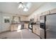 Bright and spacious kitchen with stainless steel appliances, wood cabinets, and a skylight for natural lighting at 13955 W 26Th Ave, Golden, CO 80401
