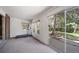 A bright bonus room features backyard access, neutral carpeting, and a brick accent wall at 13955 W 26Th Ave, Golden, CO 80401
