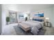 Elegantly staged main bedroom boasting a luxurious bed, artwork, and leafy outdoor views at 13955 W 26Th Ave, Golden, CO 80401