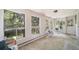 Bright sunroom with multiple windows that provide abundant natural light and views of the surrounding trees and landscaping at 13955 W 26Th Ave, Golden, CO 80401