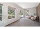 Bright sunroom with large windows, plush carpeting, and comfortable seating near sliding glass door at 13955 W 26Th Ave, Golden, CO 80401
