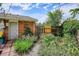Charming backyard garden featuring lush greenery, a brick walkway, vibrant flowers, and a privacy fence at 9220 Lowell Blvd, Westminster, CO 80031