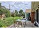 Charming backyard patio with a glass-top table, seating, string lights, and view of the expansive lawn and garden at 9220 Lowell Blvd, Westminster, CO 80031