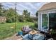 Inviting backyard patio with comfortable seating, string lights, an outdoor rug, and a glimpse of the well-kept yard at 9220 Lowell Blvd, Westminster, CO 80031