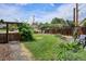 Spacious backyard featuring a well-maintained lawn, a wooden fence, mature trees and garden beds at 9220 Lowell Blvd, Westminster, CO 80031