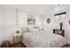 Cozy bedroom featuring a plush patterned bedspread and modern pendant lighting at 9220 Lowell Blvd, Westminster, CO 80031