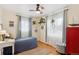 Comfortable bedroom features bright natural light and an accent red cabinet at 9220 Lowell Blvd, Westminster, CO 80031