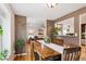 Open concept dining room with servery to kitchen and living room beyond at 9220 Lowell Blvd, Westminster, CO 80031