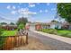Attractive home featuring well-kept lawn, inviting driveway, and colorful flowers at 9220 Lowell Blvd, Westminster, CO 80031