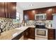 Bright kitchen featuring stainless steel appliances, granite counters, and tile backsplash at 9220 Lowell Blvd, Westminster, CO 80031