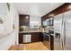View of the kitchen featuring stainless steel appliances, granite counters, and tile backsplash at 9220 Lowell Blvd, Westminster, CO 80031