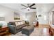 Bright living room showcasing a large couch, hardwood floors, and stylish decor at 9220 Lowell Blvd, Westminster, CO 80031