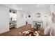 Open living room with built-in shelves, decorative mirror, and unique gold chair at 9220 Lowell Blvd, Westminster, CO 80031