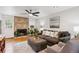 Comfortable living room featuring a stone fireplace, hardwood flooring, and ample seating at 9220 Lowell Blvd, Westminster, CO 80031