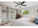 Bright main bedroom features a ceiling fan, a closet, and sliding doors to a backyard patio at 9220 Lowell Blvd, Westminster, CO 80031
