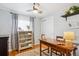 Cozy office features hardwood floors, a large desk, a ceiling fan, and natural light at 9220 Lowell Blvd, Westminster, CO 80031