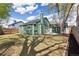 View of the home's green exterior and backyard with grass and trees at 19644 E Girard Dr, Aurora, CO 80013