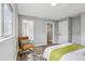 Bright bedroom features light gray walls, hardwood floors, and a cozy sitting area with natural light at 19644 E Girard Dr, Aurora, CO 80013