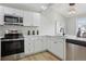 Modern kitchen with stainless appliances, white cabinets, and ample counter space at 19644 E Girard Dr, Aurora, CO 80013