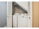 Laundry closet featuring a stacked washer and dryer and white louvered doors at 19644 E Girard Dr, Aurora, CO 80013