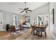 Open-concept living room with hardwood floors, ceiling fan, and plenty of natural light at 19644 E Girard Dr, Aurora, CO 80013