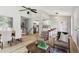Bright living room with modern decor, hardwood floors, and a ceiling fan at 19644 E Girard Dr, Aurora, CO 80013