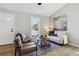 Bright living room with neutral paint, wood floors, stylish seating and large window at 19644 E Girard Dr, Aurora, CO 80013