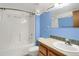 Well-lit bathroom with blue walls and a shower-tub combo at 3619 Estates Cir, Larkspur, CO 80118