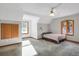 Bedroom featuring a neutral paint, carpeted floors, a window, and warm lighting at 3619 Estates Cir, Larkspur, CO 80118