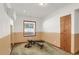 Dedicated exercise room with durable carpeting, weights, and natural light from a large window at 3619 Estates Cir, Larkspur, CO 80118