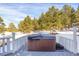 Exterior view of a private hot tub surrounded by a snow covered forest landscape at 3619 Estates Cir, Larkspur, CO 80118