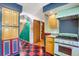 Unique kitchen features checkerboard floors, wood cabinets, and decorative archways to other rooms at 3619 Estates Cir, Larkspur, CO 80118
