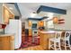 Bright kitchen with wood cabinets, retro appliances, and a unique checkerboard floor at 3619 Estates Cir, Larkspur, CO 80118