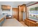 This charming kitchenette features classic wood cabinets, ample counter space, and natural light at 3619 Estates Cir, Larkspur, CO 80118