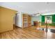 Bright loft area with hardwood floors, an old fireplace, and built-in bookshelves at 3619 Estates Cir, Larkspur, CO 80118