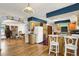 Open concept featuring kitchen, living room, and dining area with hardwood floors and colorful accents at 3619 Estates Cir, Larkspur, CO 80118