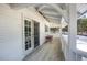 Charming porch featuring a seating area and views of a snow-covered landscape at 3619 Estates Cir, Larkspur, CO 80118