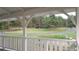 Inviting porch view overlooking a scenic drive and lush green landscape with mature trees at 3619 Estates Cir, Larkspur, CO 80118