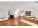 Open room featuring hardwood floors, white walls, and natural light at 3619 Estates Cir, Larkspur, CO 80118