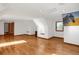 Spacious room featuring hardwood floors, white walls, and windows at 3619 Estates Cir, Larkspur, CO 80118