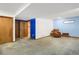 Neutral room with blue accent wall, and wood-look doors at 3619 Estates Cir, Larkspur, CO 80118